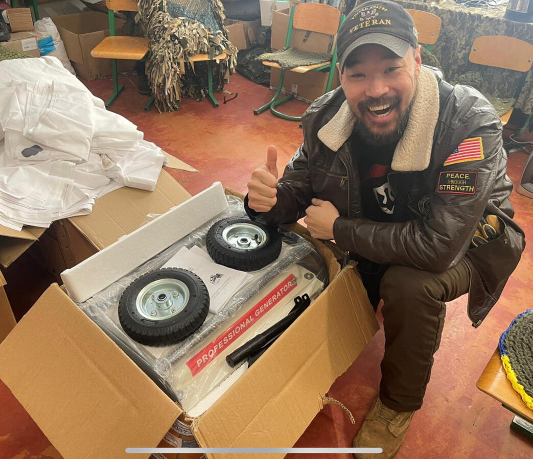 Mark J. Lindquist pictured with a generator donated to the Ukrainian Army Mark J. Lindquist pictured with a generator donated to the Ukrainian Army